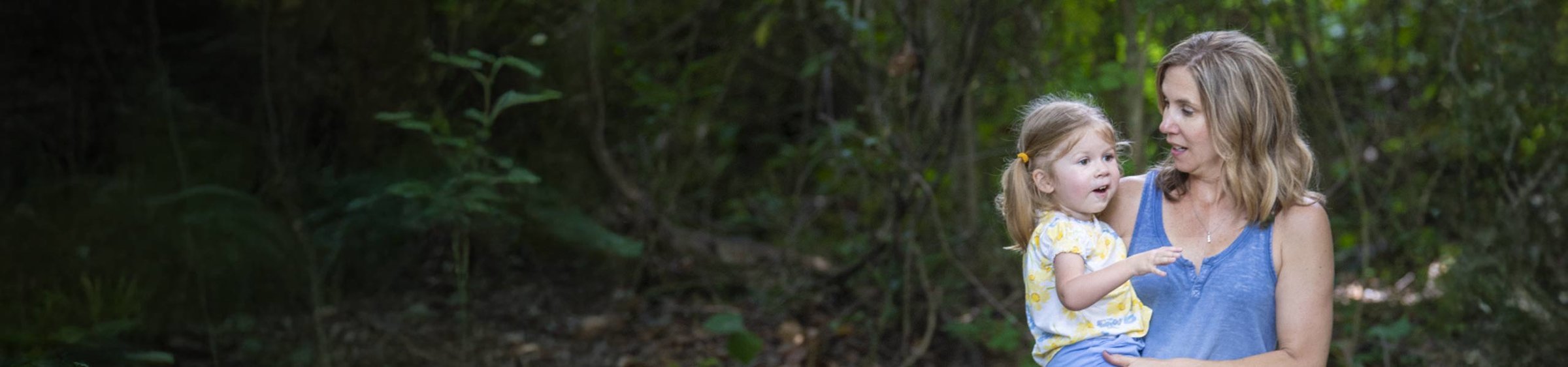 Adalyne, a child with SMA, speaking to her mother, Patti, who holds Adalyne in her arms